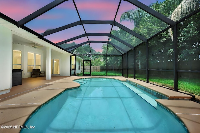 1728 Dartmoor Ln, Ponte Vedra, FL 32081 - pool at dusk with an outdoor pool, a patio, ceiling fan, and glass enclosure