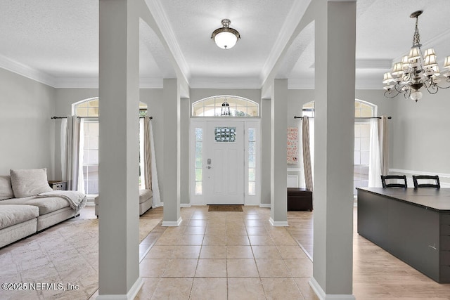 1728 Dartmoor Ln, Ponte Vedra, FL 32081 - foyer entrance with crown molding, a chandelier, a textured ceiling, and light tile patterned flooring
