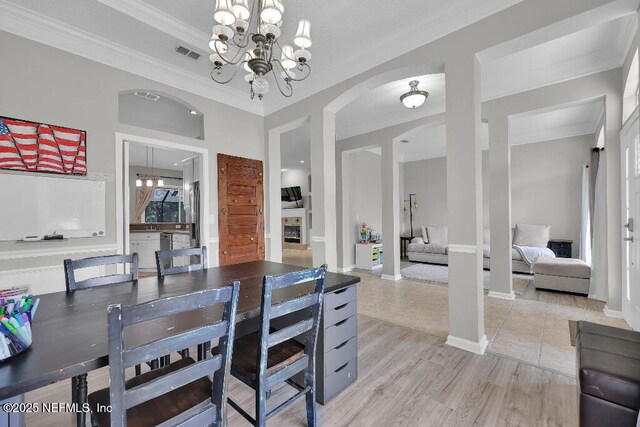 1728 Dartmoor Ln, Ponte Vedra, FL 32081 - dining room featuring a chandelier, ornamental molding, and arched walkways