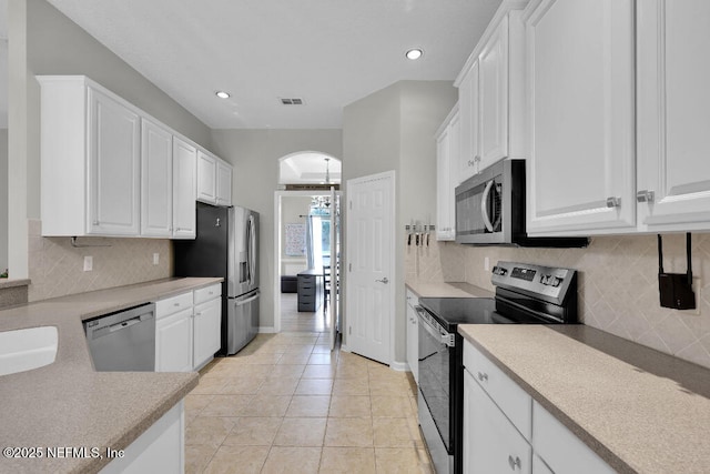 1728 Dartmoor Ln, Ponte Vedra, FL 32081 - kitchen with stainless steel appliances, white cabinetry, light countertops, decorative backsplash, and recessed lighting
