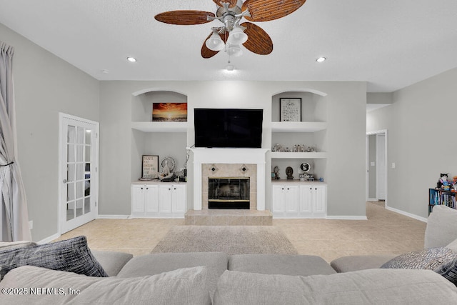 1728 Dartmoor Ln, Ponte Vedra, FL 32081 - living room featuring built in features, a tile fireplace, ceiling fan, light tile patterned flooring, and recessed lighting