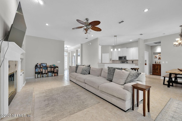 1728 Dartmoor Ln, Ponte Vedra, FL 32081 - living area featuring ceiling fan, a chandelier, a glass covered fireplace, recessed lighting, and light tile patterned flooring