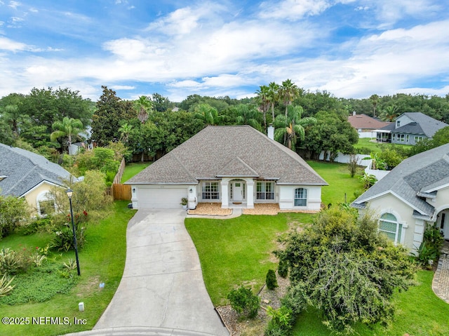 1728 Dartmoor Ln, Ponte Vedra, FL 32081 - french country style house with concrete driveway, a garage, a front lawn, a shingled roof, and stucco siding