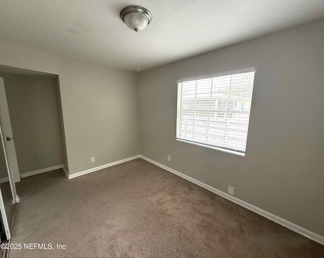 3421 Tarpon Dr, Jacksonville, FL 32277 - empty room featuring dark colored carpet and baseboards