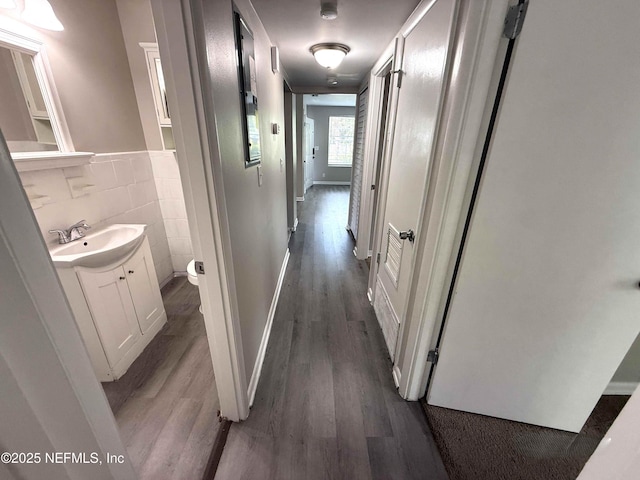3421 Tarpon Dr, Jacksonville, FL 32277 - corridor with wood finished floors and tile walls