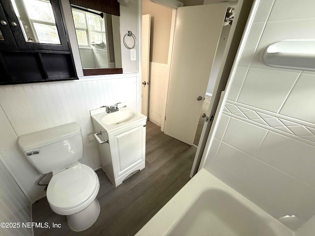 3421 Tarpon Dr, Jacksonville, FL 32277 - full bathroom featuring wainscoting, vanity, wood finished floors, and a tub