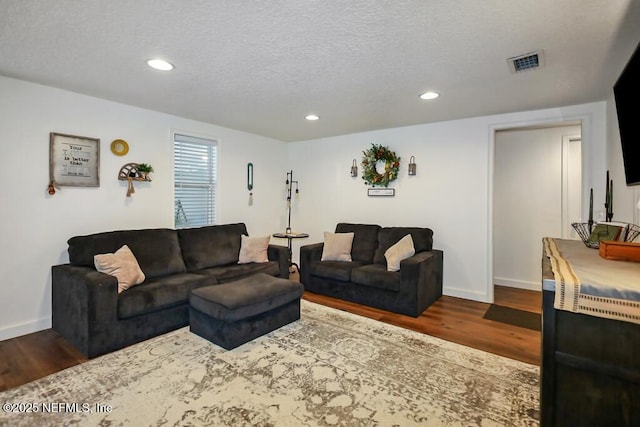 8360 Mudlake Rd, Macclenny, FL 32063 - living room featuring dark wood-style floors, a textured ceiling, and recessed lighting