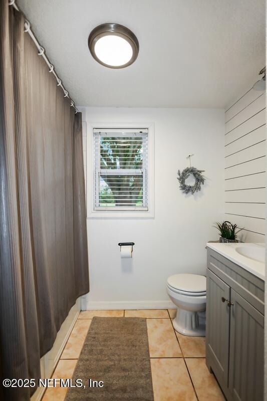 8360 Mudlake Rd, Macclenny, FL 32063 - full bath with tile patterned flooring, vanity, and curtained shower