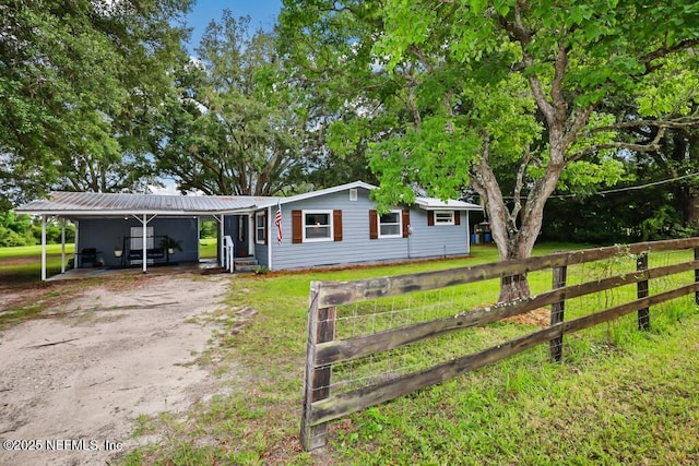 8360 Mudlake Rd, Macclenny, FL 32063 - single story home with dirt driveway, a metal roof, and a carport