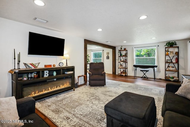8360 Mudlake Rd, Macclenny, FL 32063 - living area with wood finished floors, recessed lighting, and a glass covered fireplace