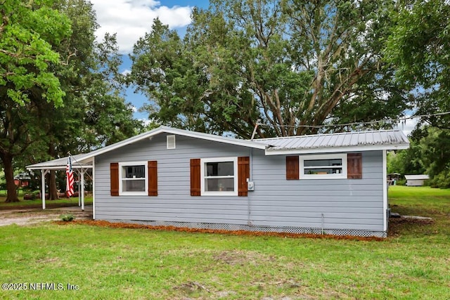 8360 Mudlake Rd, Macclenny, FL 32063 - view of property exterior with a carport, a yard, and a metal roof