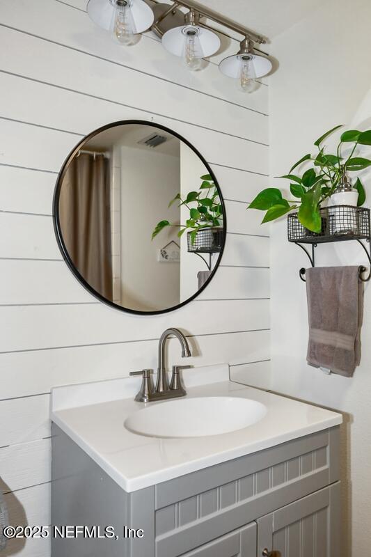 8360 Mudlake Rd, Macclenny, FL 32063 - bathroom with vanity and wood walls