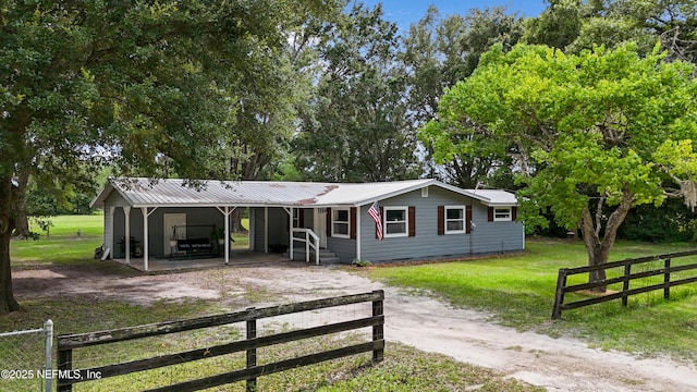 8360 Mudlake Rd, Macclenny, FL 32063 - view of front of house with dirt driveway, a metal roof, crawl space, and view of wooded area