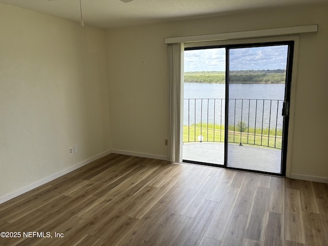 32 Ocean Palm Dr S Unit 320, Flagler Beach, FL 32136 - unfurnished room featuring a water view, wood finished floors, and plenty of natural light
