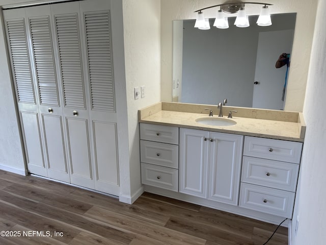 32 Ocean Palm Dr S Unit 320, Flagler Beach, FL 32136 - bathroom with a closet, vanity, a textured wall, wood finished floors, and a chandelier