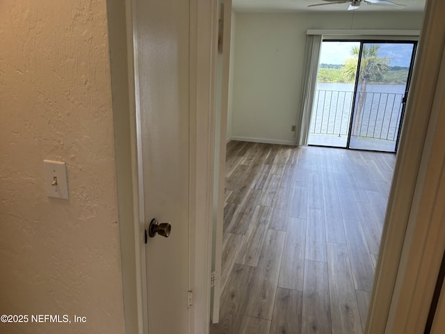 32 Ocean Palm Dr S Unit 320, Flagler Beach, FL 32136 - empty room featuring a textured wall, wood finished floors, a ceiling fan, and a water view