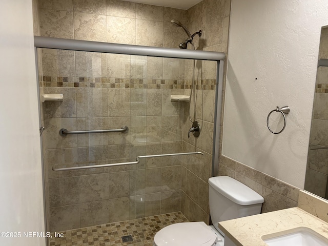 32 Ocean Palm Dr S Unit 320, Flagler Beach, FL 32136 - full bathroom featuring a stall shower, vanity, and tile walls