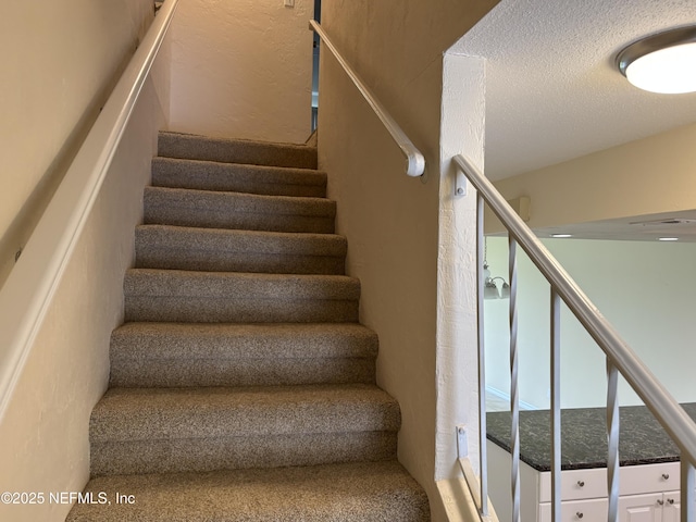 32 Ocean Palm Dr S Unit 320, Flagler Beach, FL 32136 - stairs featuring a textured ceiling and a textured wall