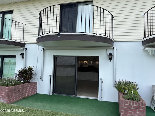 32 Ocean Palm Dr S Unit 320, Flagler Beach, FL 32136 - doorway to property with stucco siding and a balcony