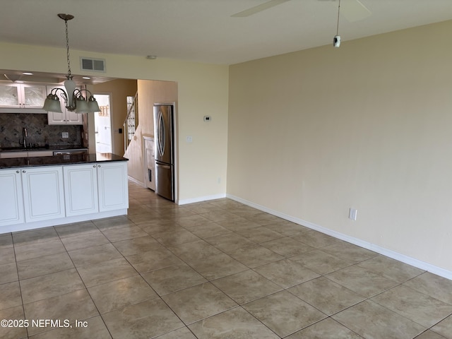 32 Ocean Palm Dr S Unit 320, Flagler Beach, FL 32136 - kitchen featuring freestanding refrigerator, dark countertops, backsplash, light tile patterned floors, and hanging light fixtures