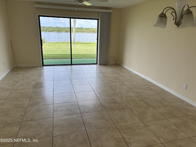 32 Ocean Palm Dr S Unit 320, Flagler Beach, FL 32136 - empty room with ceiling fan, light tile patterned flooring, and a water view