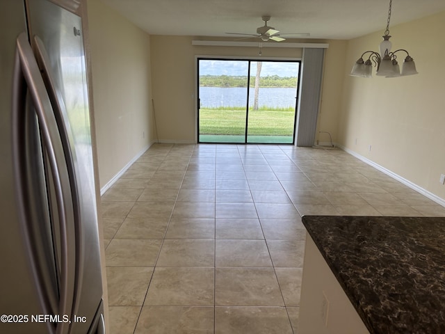 32 Ocean Palm Dr S Unit 320, Flagler Beach, FL 32136 - empty room featuring light tile patterned floors, a chandelier, a water view, and a ceiling fan