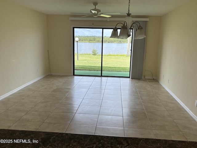 32 Ocean Palm Dr S Unit 320, Flagler Beach, FL 32136 - spare room with tile patterned flooring, a water view, and a ceiling fan