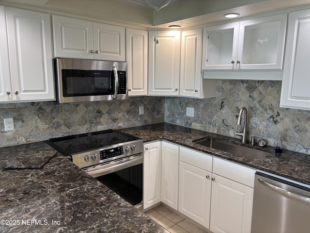 32 Ocean Palm Dr S Unit 320, Flagler Beach, FL 32136 - kitchen with appliances with stainless steel finishes, white cabinetry, and tasteful backsplash