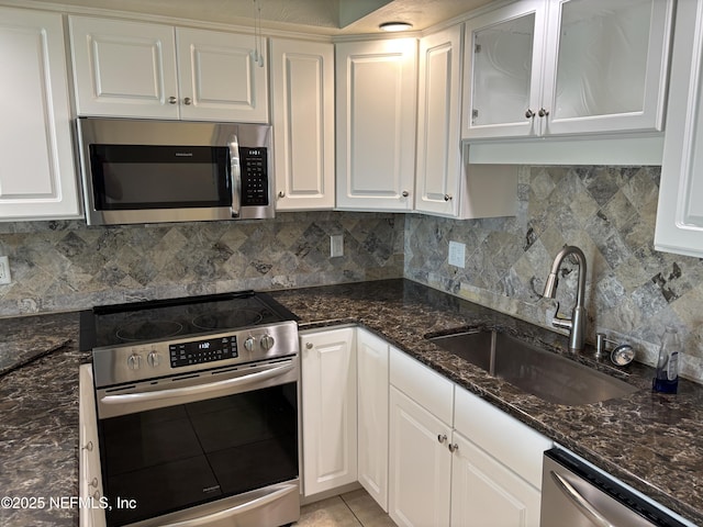 32 Ocean Palm Dr S Unit 320, Flagler Beach, FL 32136 - kitchen featuring stainless steel appliances, white cabinetry, and decorative backsplash