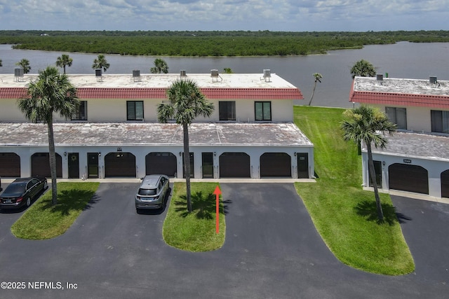 32 Ocean Palm Dr S Unit 320, Flagler Beach, FL 32136 - view of property with asphalt driveway, a water view, and an attached garage