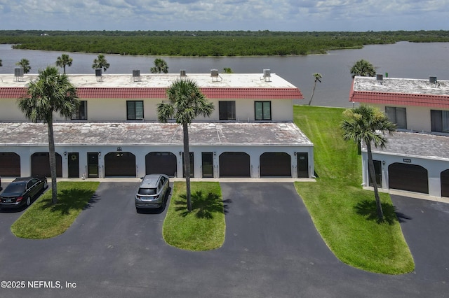 32 Ocean Palm Dr S Unit 320, Flagler Beach, FL 32136 - view of property featuring driveway, a water view, and a garage