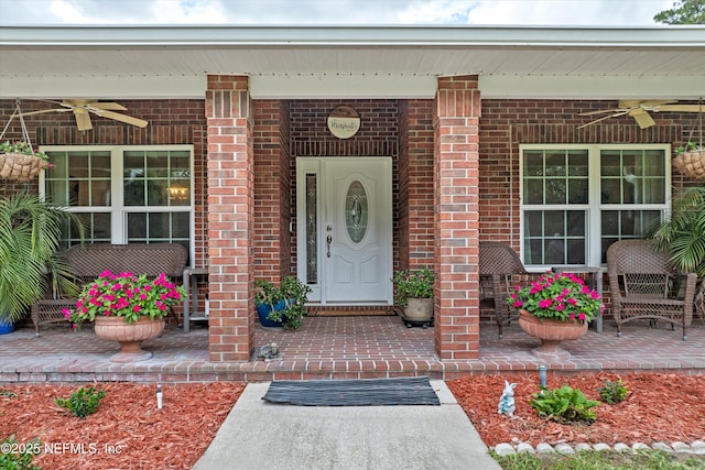5566 Don Manuel Rd, Elkton, FL 32033 - view of exterior entry with a ceiling fan, covered porch, and brick siding