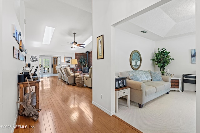 5566 Don Manuel Rd, Elkton, FL 32033 - living area featuring a skylight, light wood-style flooring, ceiling fan, and lofted ceiling
