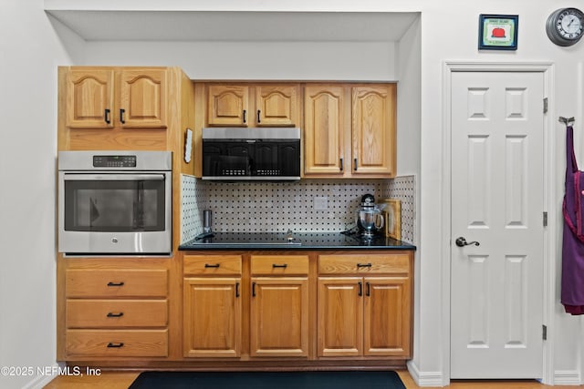 5566 Don Manuel Rd, Elkton, FL 32033 - kitchen featuring stainless steel appliances, dark countertops, and backsplash