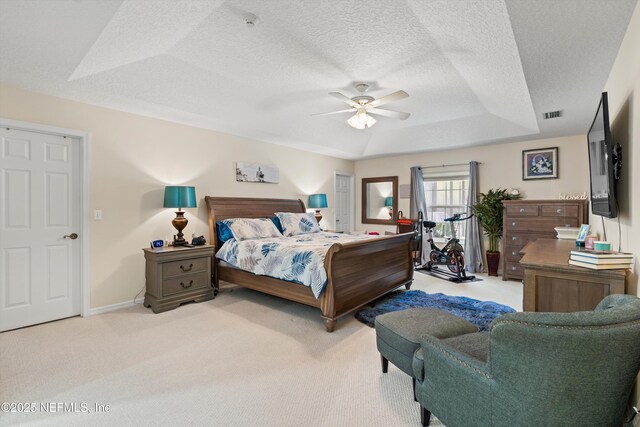 5566 Don Manuel Rd, Elkton, FL 32033 - bedroom featuring light colored carpet, a raised ceiling, a textured ceiling, and a ceiling fan