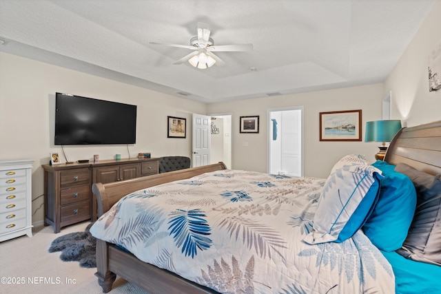 5566 Don Manuel Rd, Elkton, FL 32033 - bedroom featuring light colored carpet, a raised ceiling, and ceiling fan
