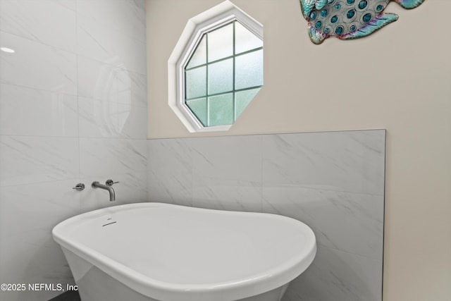 5566 Don Manuel Rd, Elkton, FL 32033 - bathroom featuring tile walls and a freestanding bath