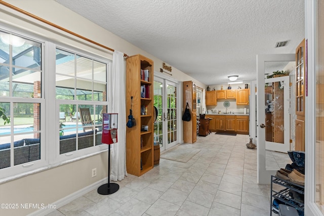 5566 Don Manuel Rd, Elkton, FL 32033 - hallway with french doors and a textured ceiling