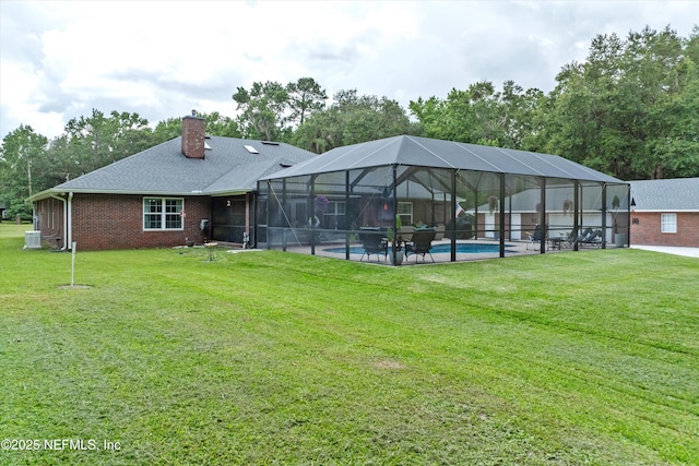 5566 Don Manuel Rd, Elkton, FL 32033 - back of property with an outdoor pool, a lawn, a chimney, and a patio area