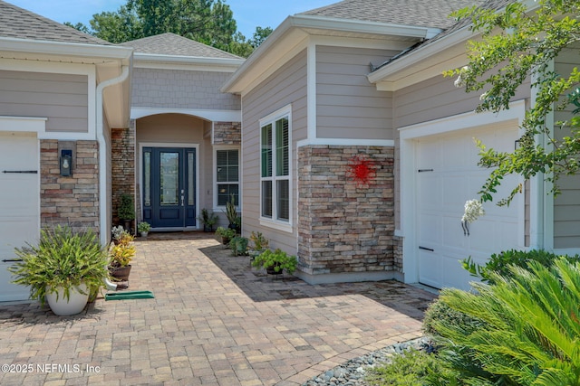 363 Latrobe Ave, Saint Augustine, FL 32095 - entrance to property featuring stone siding, a shingled roof, and a garage