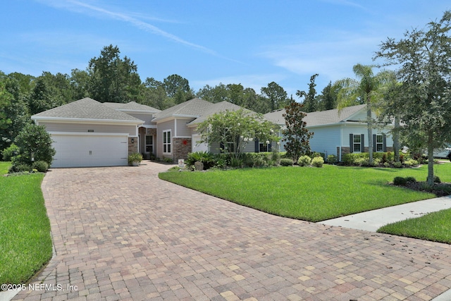 363 Latrobe Ave, Saint Augustine, FL 32095 - ranch-style home with a garage, decorative driveway, a front lawn, and stone siding
