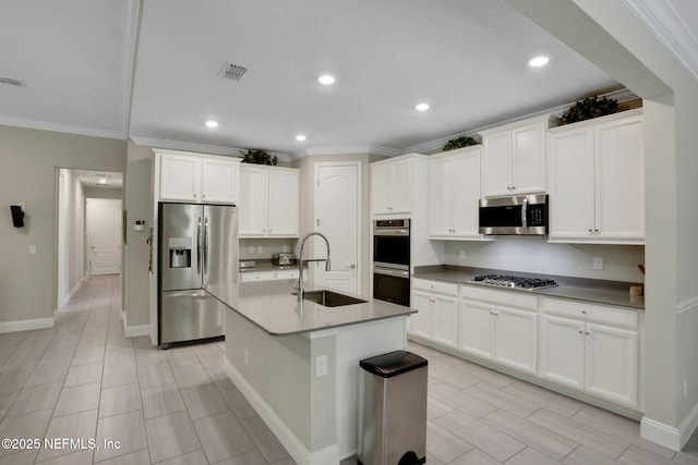363 Latrobe Ave, Saint Augustine, FL 32095 - kitchen featuring stainless steel appliances, ornamental molding, white cabinets, recessed lighting, and an island with sink