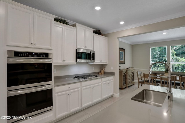 363 Latrobe Ave, Saint Augustine, FL 32095 - kitchen featuring appliances with stainless steel finishes, crown molding, white cabinetry, recessed lighting, and light tile patterned floors