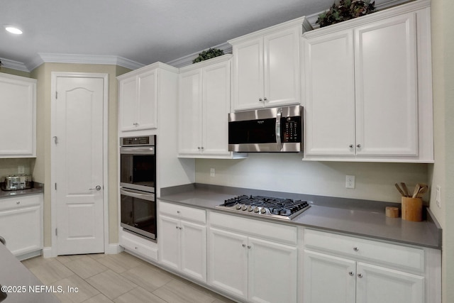 363 Latrobe Ave, Saint Augustine, FL 32095 - kitchen featuring stainless steel appliances, crown molding, white cabinets, and light tile patterned floors