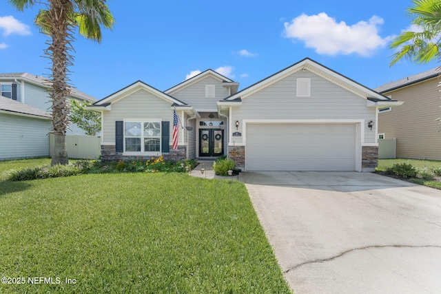 47 Mercutio Ln, Saint Augustine, FL 32092 - view of front of home with stone siding, concrete driveway, a front lawn, and a garage