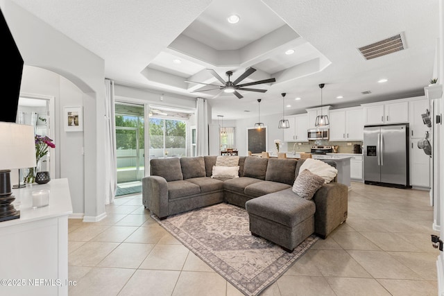 47 Mercutio Ln, Saint Augustine, FL 32092 - living room featuring ceiling fan, light tile patterned flooring, arched walkways, coffered ceiling, and recessed lighting