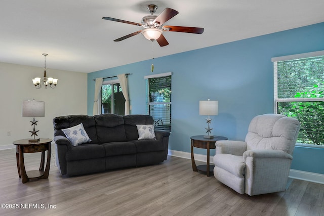 35 Root Ln, Saint Augustine, FL 32084 - living area featuring healthy amount of natural light, light wood-style floors, a chandelier, and ceiling fan