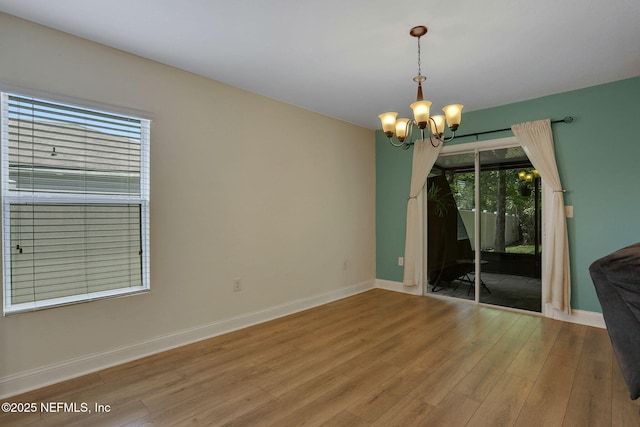 35 Root Ln, Saint Augustine, FL 32084 - spare room featuring a chandelier and wood finished floors