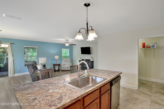 35 Root Ln, Saint Augustine, FL 32084 - kitchen with a chandelier, dishwasher, brown cabinets, and open floor plan