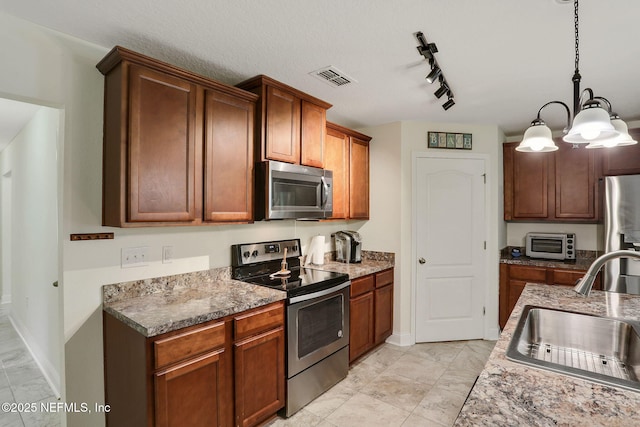 35 Root Ln, Saint Augustine, FL 32084 - kitchen with appliances with stainless steel finishes, decorative light fixtures, light marble finish flooring, and a chandelier